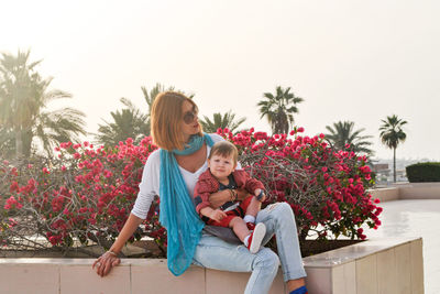 Beautiful young woman walks with a child in the city. motherhood is joy. mother and son