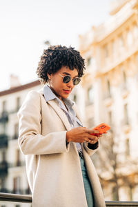 Young man using mobile phone outdoors