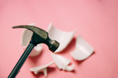 Close-up of human hand against pink background