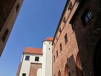 Low angle view of bell tower against blue sky