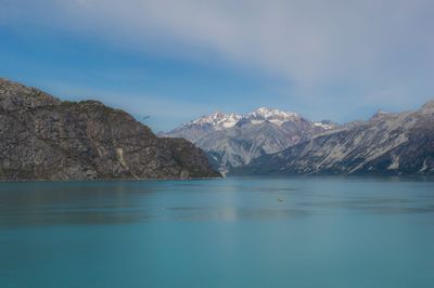 Scenic view of lake and rocky mountains against sky