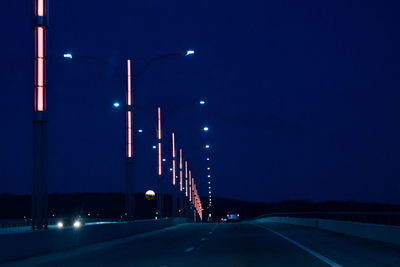 View of illuminated street lights at night