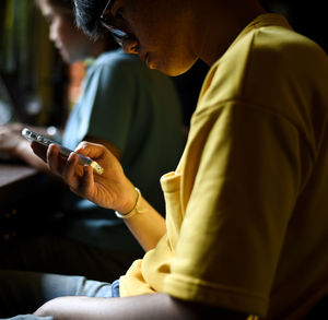 Midsection of man using mobile phone
