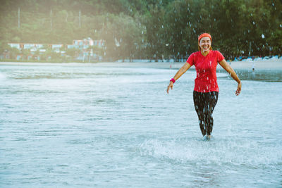 Full length of man standing in water