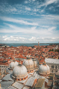 Aerial view of town against cloudy sky