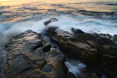 Scenic view of rocks at sea shore