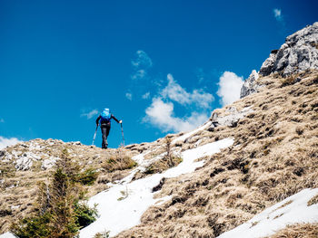 Low angle view of people on snow covered mountain