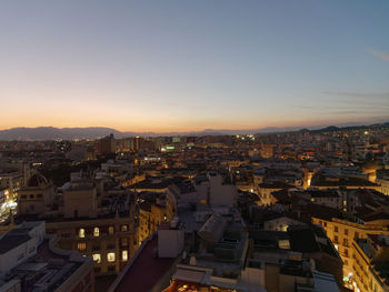 High angle shot of townscape against sky at sunset