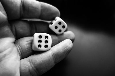 Close-up of person holding dices