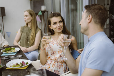 Portrait of smiling friends having food at home