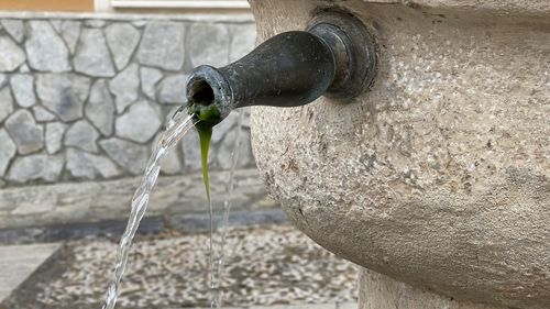 Close-up of water fountain against white wall