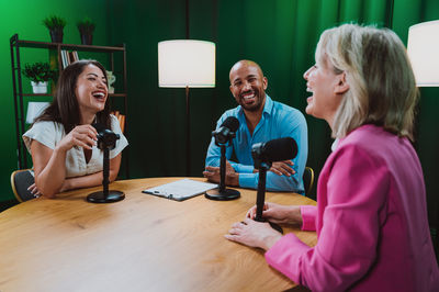 Young woman using mobile phone while sitting at home