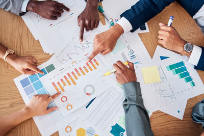 Midsection of business colleagues working on table