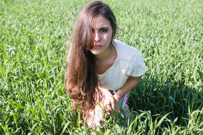 Beautiful latin american woman in green field
