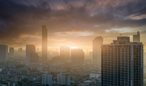 Cityscape in the morning with sunrise sky. crowded of skyscraper buildings at downtown district.