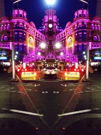 Illuminated city against sky at night