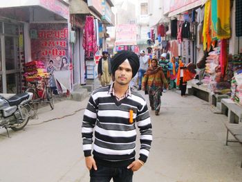 Full length of woman standing on street in city