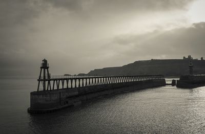 Whitby pier against sky