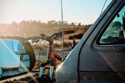 Bike and van with reflection of side-view mirror at sunset 