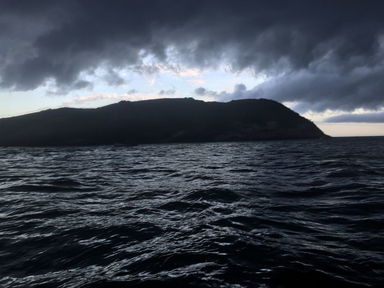 SCENIC VIEW OF SEA AGAINST STORM CLOUDS