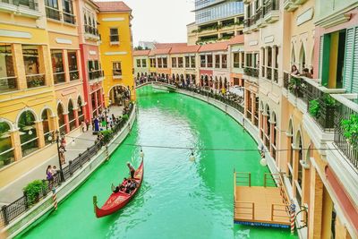 View of boats in canal along buildings