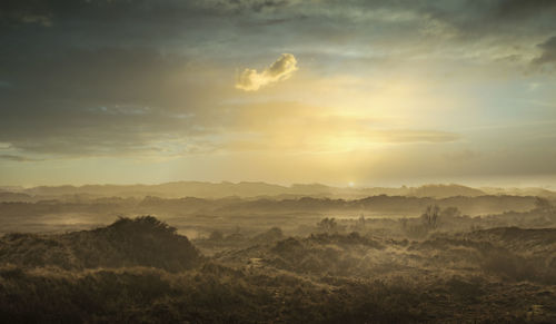 Scenic view of landscape against sky during sunset