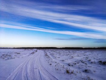 Snow covered land against sky