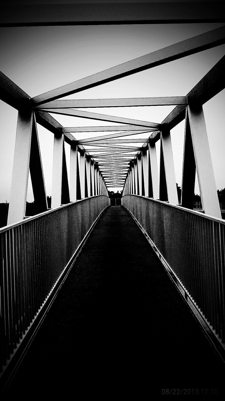 the way forward, diminishing perspective, connection, built structure, architecture, vanishing point, long, bridge - man made structure, in a row, low angle view, railing, metal, clear sky, transportation, sky, no people, day, outdoors, bridge, footbridge