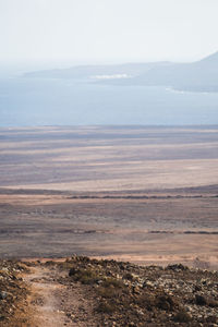 Scenic view of landscape against cloudy sky in lanzarote 