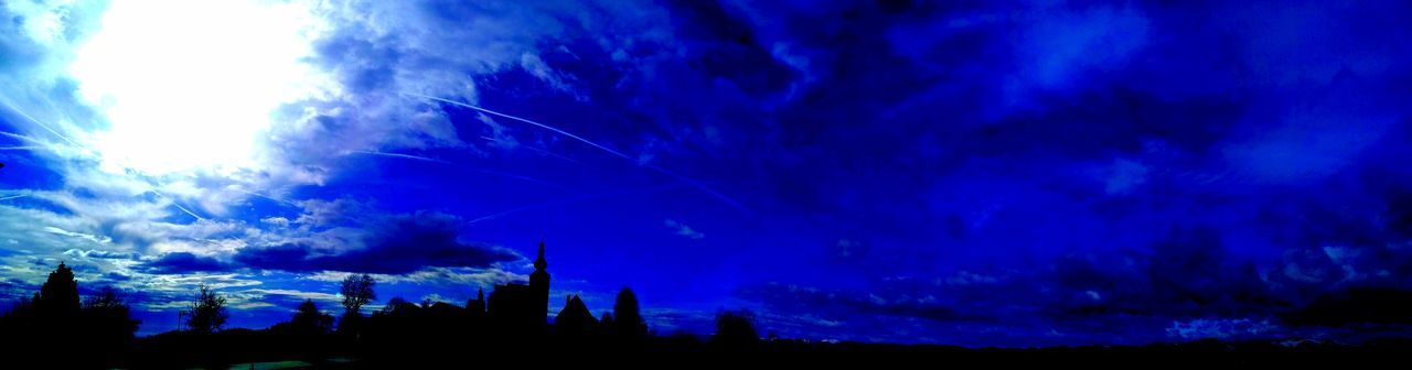 LOW ANGLE VIEW OF SILHOUETTE BUILDINGS AGAINST SKY