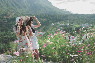 Female friends standing against mountain