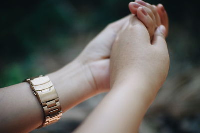 Close-up of woman holding hands