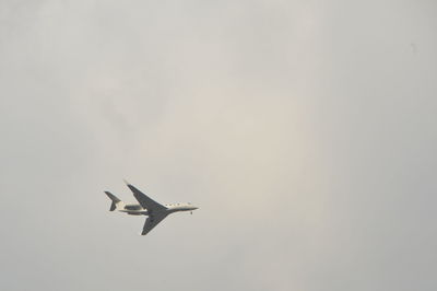 Low angle view of airplane flying in sky