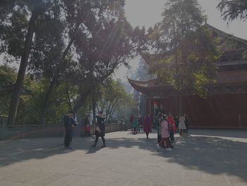 People in temple against building