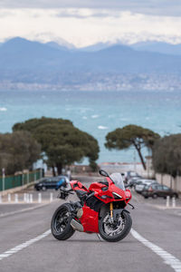 Rear view of man riding motor scooter on road