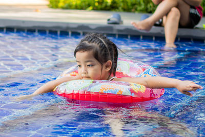 Cute girl with inflatable in swimming pool