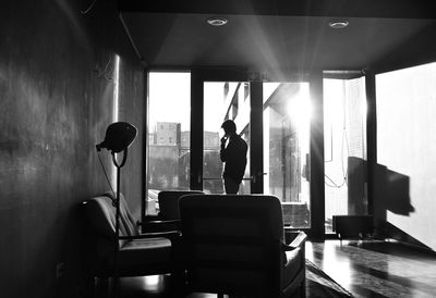 Man talking on mobile phone in living room