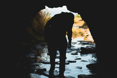 Rear view of silhouette man standing outdoors