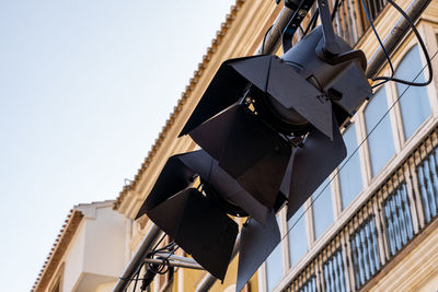 Lighting spotlights hooked to metal bars, outside