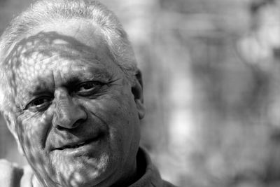 Close-up portrait of man smiling outdoors