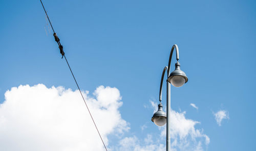 Low angle view of cables against blue sky