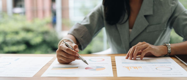 Midsection of businesswoman working at office