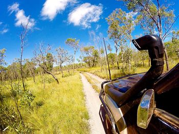 Close-up of car on landscape against sky