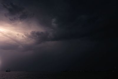 Scenic view of sea against storm clouds