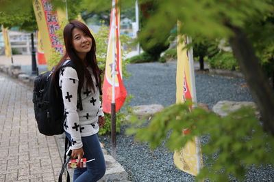 Portrait of smiling woman standing outdoors