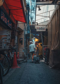 Man on street amidst buildings in city