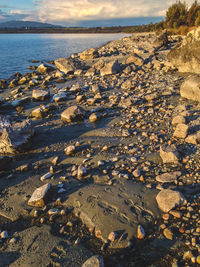 Scenic view of beach against sky during sunset