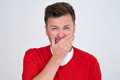 Portrait of young man against white background