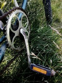 Close-up of bicycle wheel on grassy field