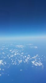 Aerial view of sea against blue sky